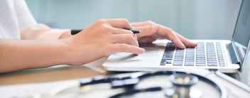hands typing on laptop