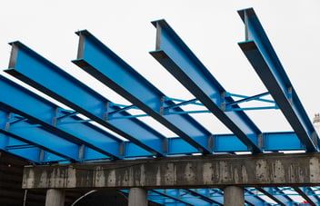 blue roof beams in a manufacturing setting