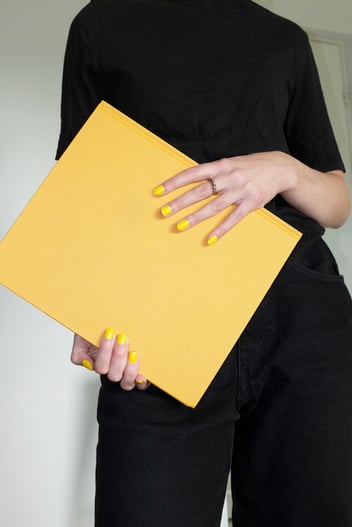 Person holding yellow notebook