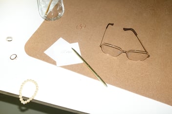 Glasses and note taking materials on table