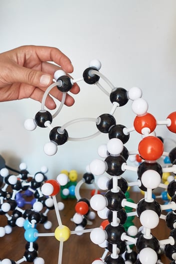 Hand setting up molecule model kit