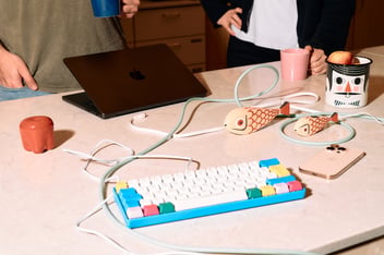 Colorful keyboard and a laptop on a table
