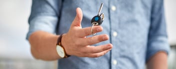 Person holding apartment keys in hand