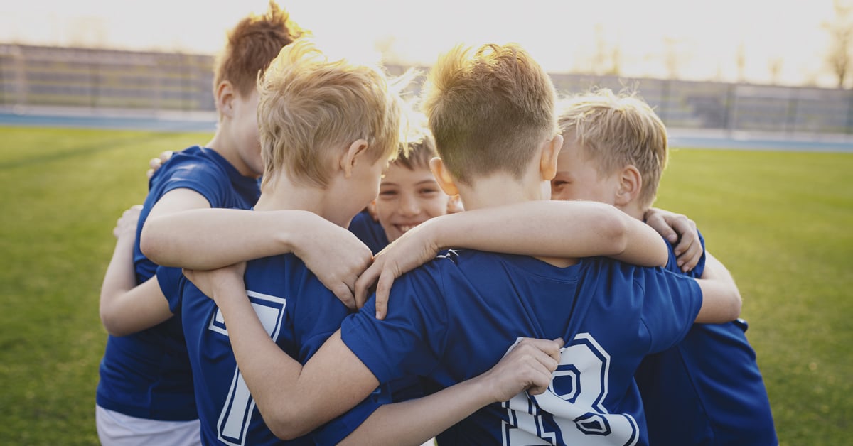 Kids having a football huddle