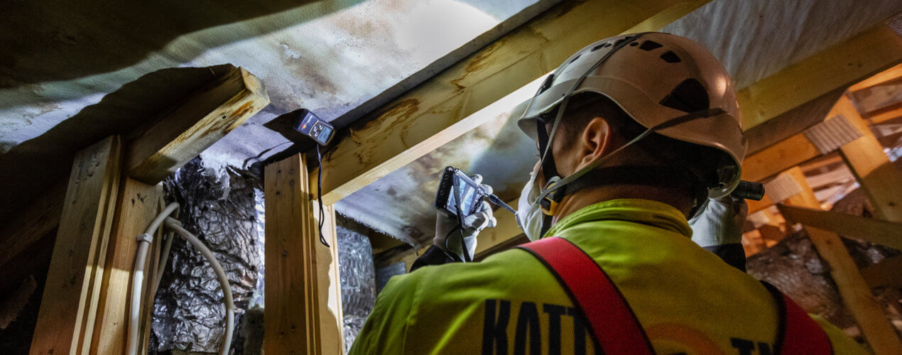 Worker inspecting roof