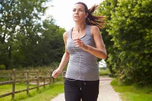 Woman running and listening to music