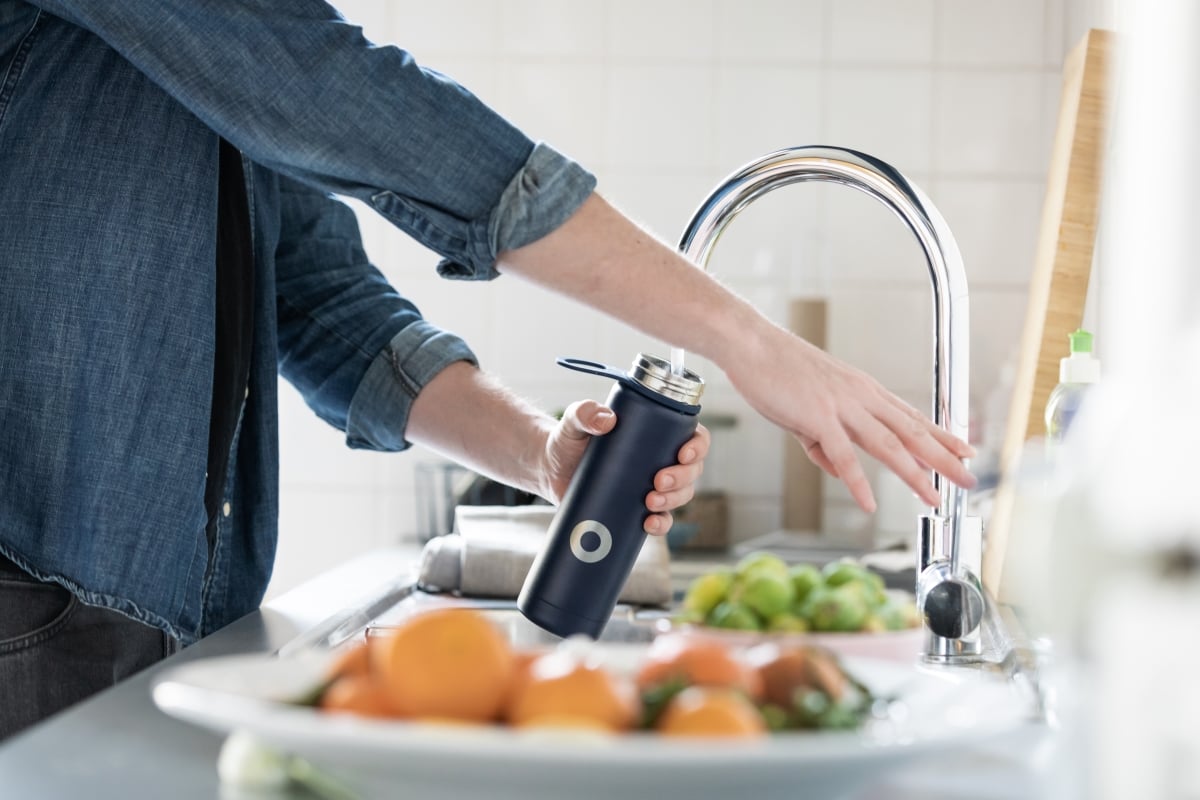 Filling up water bottle under tap