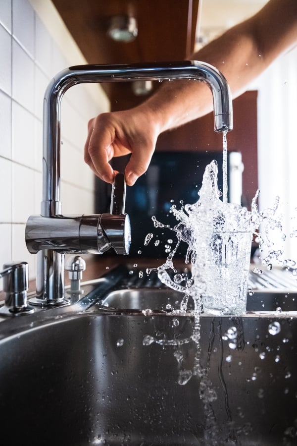 Water tap filling glass